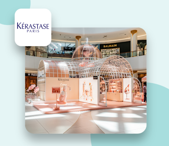 Photo of a pink green house where the Kerastase pop up store is hosted with the logo of the kérastase brand